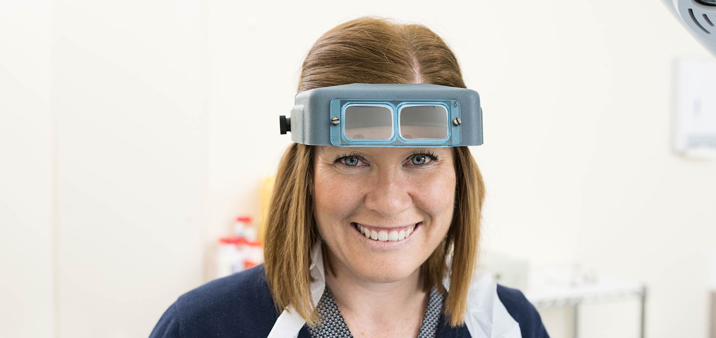 A nurse wearing magnifying loupes.