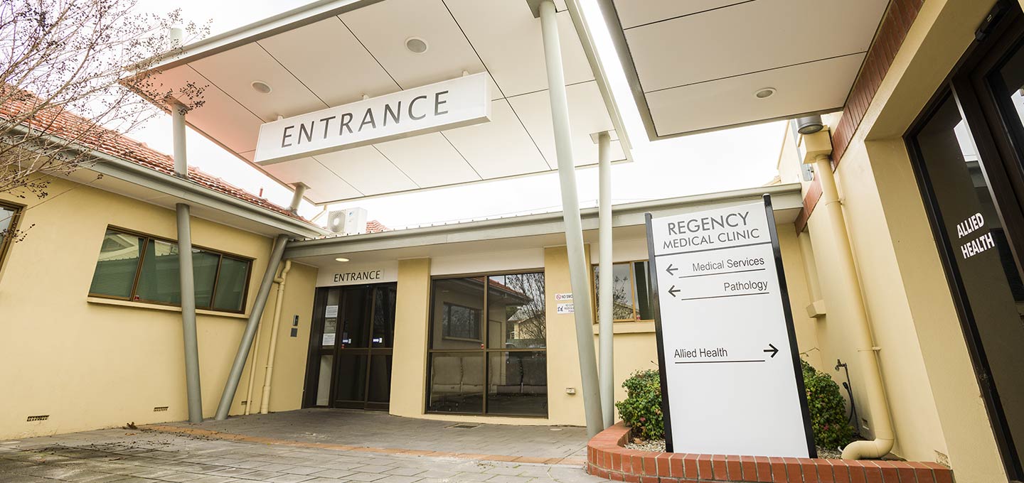 The clinic entrance on Regency Road, with signs for medical services, pathology and allied health.